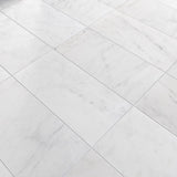 White marble tiles arranged in a herringbone pattern