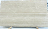 Beige marble slab with visible veins on a white background