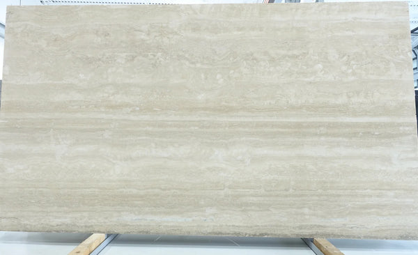 Beige marble slab with visible veins on a white background